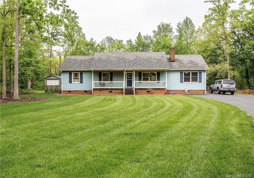 Easy living in this low maintenance vinyl home with lush green lawn and irrigation system.  3 Br / 2 full BA all on one level. Main level bonus room is currently used as a playroom but easily converts to office/study or other use with side entrance. Living room features masonry fireplace and stained bead board wainscoting & chair rail.