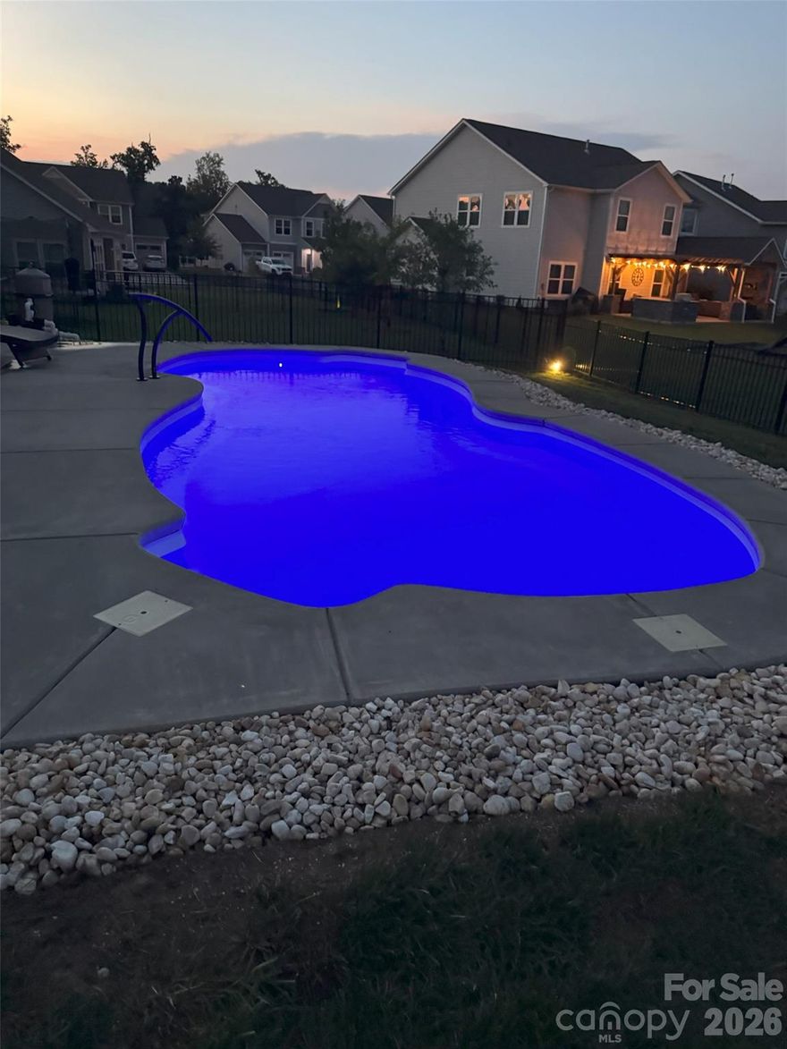 This is A MUST SEE INSIDE Fabulous Semi- Custom home has  a private inground  4 HUGE Bedrooms, 3-full Baths —including optional  2nd primary suite upstairs—this residence offers space, style, and comfort and located in The GATED Manor at Handsmills– Lake Wylie

The open floor plan showcases a gourmet kitchen with a large granite island, generous counter space, soft closed doors and premium finishes. The main-level primary suite includes a spacious sitting room, a designer bathroom with separate shower and garden tub, and a custom walk-in closet.

Enjoy year-round relaxation in the sunroom, which opens to a fenced backyard with a new in-ground pool, expanded patio, and plenty of room for entertaining.

Community amenities include a playground, walking trails, clubhouse, fitness center, lake-view pool, leased boat slips, and RV/boat storage.

Ask about potential lender credit—up to $2,500!