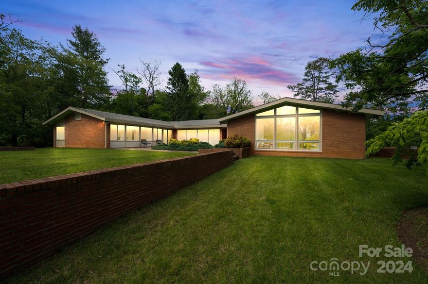 Own a mid-century architectural masterpiece! This 1959 home was designed by famed architect Bert King and is situated on a 3-acre estate in the coveted Lakeview Park neighborhood. Preserved with tasteful updates, this residence stands one of the finest examples of mid-century architecture in the Southeast. Significant original features include wide wood paneling, site-built cabinetry, mosaic confetti countertops, lighting fixtures, slate flooring, telescoping patio doors, and much more. Discerningly designed updates include a spa-like primary bathroom that boasts artist-made concrete countertops, a steam shower, an oversized soaking tub, and heated floors. Bright and airy one-level plan with hidden features everywhere. Magnificent Mt Pisgah views from the yard and primary bath. Views from the sunken living room possible with limited clearing. Just a short stroll to Beaver Lake and the Bird Sanctuary, this is a spectacular home in one of Asheville's finest neighborhoods. See brochure.