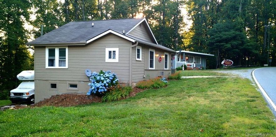 Updated small Cottage/Bungalow with separate shop in the Village of Flat Rock. Refinished hardwood floors, new double insulated windows, ceiling fans, new membrane roof on gallery, all appliances included. Both buildings recently painted, large wooded lot, heating & air in both buildings. New electrical wiring, plumbing & drywall, insulation added to house attic & walls when remodeled. Ideal location for someone who wants to live in house & have shop next door. Unfinished basement in house.