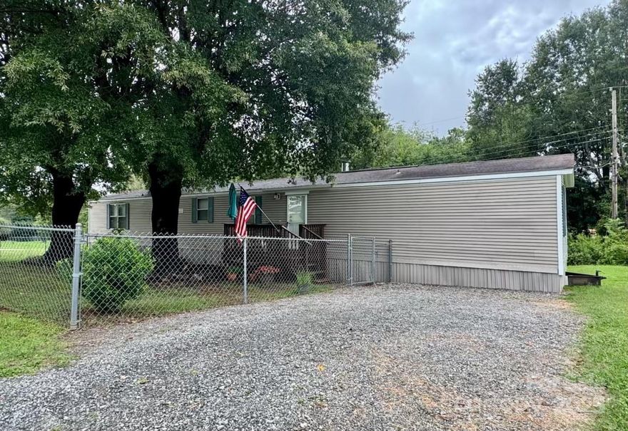 Terrific opportunity to purchase a well-maintained home at an unbeatable price!  Situated on a .24acre lot, this single-wide mobile home is just minutes from Forest City and Hwy 74.  Public water plus an existing well (not currently connected to the house).  Gas furnace and gas log fireplace w/leased propane tank.  Front porch with fenced area and a deck in the back.  Split bedroom layout w/primary and two additional bedrooms w/shared bath. CASH ONLY - manufactured home is not on a permanent foundation.