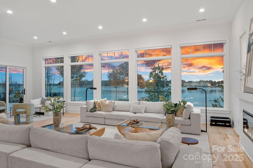 A breathtaking modern farmhouse infused with contemporary design and timeless architectural charm—defined by clean lines, rich natural textures, and over 300 feet of extraordinary panoramic Lake Norman shoreline. Built in 2022 and fully renovated in 2025 with all-new designer selections, this estate delivers exceptional luxury, natural light, and architectural sophistication. Perfectly positioned on a premium peninsula-style lot, the property captures uninterrupted, long-range water views from nearly every room, creating an atmosphere of serenity that is unmatched on the lake. Two natural sandy beaches frame the shoreline, offering an effortless lakeside lifestyle.

Inside, the main level showcases 12' ceilings, expansive walls of glass, and seamless indoor-outdoor flow designed to maximize the views at every turn. The gourmet kitchen features custom cabinetry, an oversized island, premium appliances, and breathtaking lake views, complemented by a fully equipped scullery for additional prep and storage. The lakeside primary suite is a true retreat with picture-window views and a spa-inspired bath anchored by a freestanding tub and oversized glass shower.

The walk-out lower level expands your living and guest accommodations with generous bedrooms, recreation spaces, and private access to the second garage—ideal for multigenerational living or extended stays. Outdoor features include new designer landscaping, an outdoor shower, and a brand-new seawall. A new two-level dock is currently under construction for mid-December completion, and approved pool plans offer even more opportunity to customize this remarkable property.

A rare waterfront offering where timeless modern architecture, spectacular long-range views, and a premier Cornelius location come together—Lake Norman living at its absolute finest.