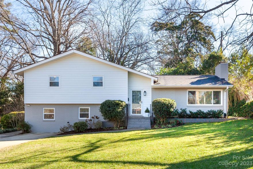 BEST OFFERS BY 8PM, SAT 1/20. Welcome to this stunning Midcentury Split Level home in Merry Oaks, just 2 miles from bustling Plaza Midwood. This spacious residence boasts 4 bedrooms, 2 full baths, & sits on a generous .41 acre lot. A charming wood-burning fireplace graces the living room, while the open dining room makes entertaining a breeze. The expansive kitchen offers ample storage and SS appliances with lush backyard views. Upstairs, you'll find 3 bedrooms & a beautifully renovated bathroom with double vanity, full tub, & separate shower w/a glass enclosure. The lower level den can serve as a home office, playroom, or gym. The 4th bedroom and 2nd bath on this level offer guests plenty of privacy. The outdoor patio is perfect for hosting barbecues, and a newer shed provides ideal storage. The backyard showcases pomegranate, fig and peach trees, flowering shrubs & a basketball court, while the front of the home offers stunning sunsets and winter views of the city skyline.