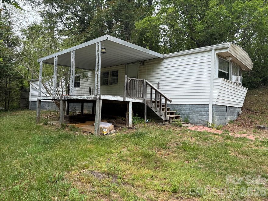 Opportunity awaits with this 1985 single-wide home on an expansive .58 lot just minutes from charming downtown Saluda.  City water and sewer are connected, providing a strong foundation for the investor, renovator, or buyer looking to create value through updates or explore future possibilities.  Though the home is ready for some improvements, it has been rented long term for $1200/month, demonstrating good income potential.  Conveniently located near the shops and dining of Saluda and the scenic hiking and whitewater of the Green River Gorge, the property also offers plenty of room to spread out while at home.  All told, the desirable location, strong income history, and opportunity to renovate and add value mean this property is full of potential for the buyer with vision.