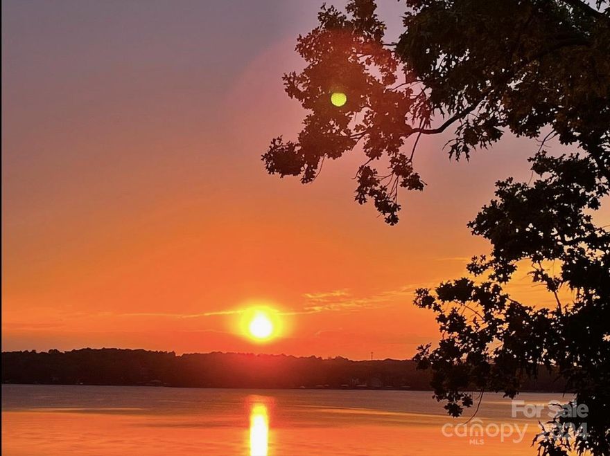 Awesome, very hard to find 1.45 acre WATERFRONT property with 174 sf of waterfront, sandy beach and amazing long-range views! Great location at the end of Brawley School Rd, past The Point Golf Course-Highly sought after! GORGEOUS SUNSET VIEWS!!! No HOA dues- No restrictions- low Iredell County taxes- partially wooded- 4 bed septic permit (3 bed installed)- Sandy beach. PLUS- Charming updated house w/updated kitchen, quartz countertops, gas stove, hardwood floors, great room w/stone fireplace, updated bathrooms, large bonus room w/breathtaking views you'll never get tired of! It doesn't stop there..also enjoy the convenience of the adorable detached "She-Shed" w/kitchenette, living room, fireplace, upstairs loft and bath. Feel like you are on vacation EVERYDAY!!!