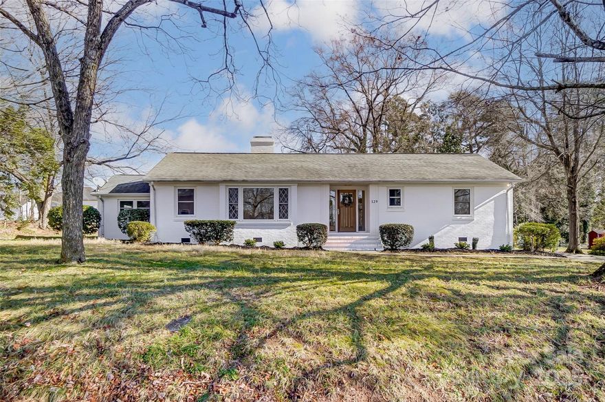 This beautifully renovated brick ranch offers a modern, classic charm! Fall in love with the Craftsman-style wood front door that opens into a living room bathed in natural light and a wood-burning fireplace. The kitchen is a highlight with soft-close shaker cabinets, a cloud island, stainless steel appliances, slide-in range and signature hood, creating a timeless look. A bar/prep sink next to the fridge makes cooking a breeze. Waterproof LVP throughout! The primary bedroom boasts a walk-in closet and en-suite bath including a tiled walk-in shower and Carrera marble dual vanity, creating a spa-like feel. The home has 2 additional bedrooms, a full bathroom and a bonus room with a tongue-and-groove ceiling. The back patio is ideal for outdoor entertaining! Storage is endless with a 2-car garage and 1-car detached garage. This prime location is close to Liberty Park, Mill One, and shops/restaurants in downtown Mooresville! No HOA and Mooresville school district, this home is a must-see!