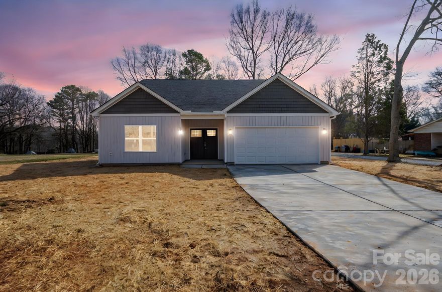 Brand New Construction | No HOA | .45 Acres | One-Level Living
Welcome to 318 Sunrise Circle in Shelby — a beautifully crafted new construction home offering 3 bedrooms, 2 bathrooms, and approximately 1,752 square feet of thoughtfully designed living space, situated on nearly half an acre in an established neighborhood. Step inside and you’ll immediately notice how the home beams with natural sunlight, highlighting the open floor plan and seamless flow between the living, dining, and kitchen areas. Designed for both everyday living and entertaining, the oversized kitchen island with built-in storage anchors the heart of the home, providing abundant prep space and additional seating. Enjoy no carpet throughout for a clean, modern look and easy maintenance. The private primary suite offers a spacious bathroom with dual vanities and a generous walk-in closet, creating a comfortable retreat at the end of the day. Both bathrooms feature stylish tile flooring for a polished finish. Relax or entertain on the covered back patio overlooking your expansive backyard. Additional highlights include a 2 car garage w/ new epoxy paint and a superb convenient location close to shopping, schools, dining, and commuter routes. Ready for its first owner and built for today’s lifestyle — this is the one you’ve been waiting for!