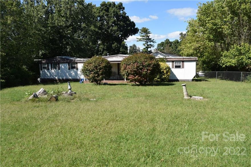 Unique Woodfin property featuring a Mobile home with addition and fenced in yard. Property includes additional "fixer upper" home with a large carport and 2 lots 1 cleared (fenced in) lot available for future construction with Community Shopping Zoning and easy access to I-26 and downtown Asheville.