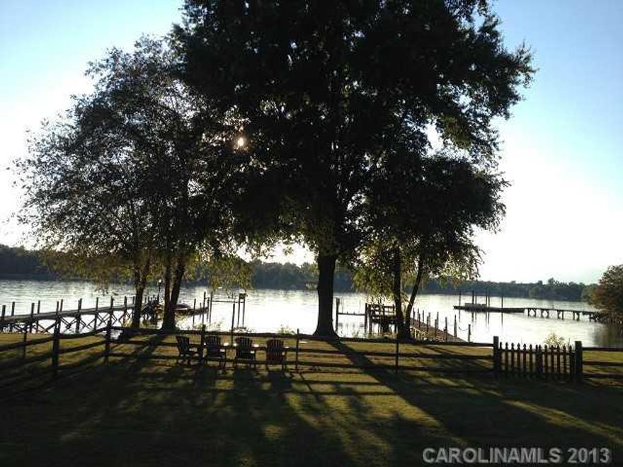 Live near The Point without paying the price! WATERFRONT & Full Brick Ranch home  w/ stunning views of LKN at Marker D7. Kit w/ newer granite counters & stainless appliances, Parquet flooring, GR w/ fireplace and tile & granite in both BA's. Front and Rear Covered Porches, Fenced Yard, Flat  lot, Storage Shed, Pier and Dock. Popular Brawley School Rd location near Trump National Golf Club.