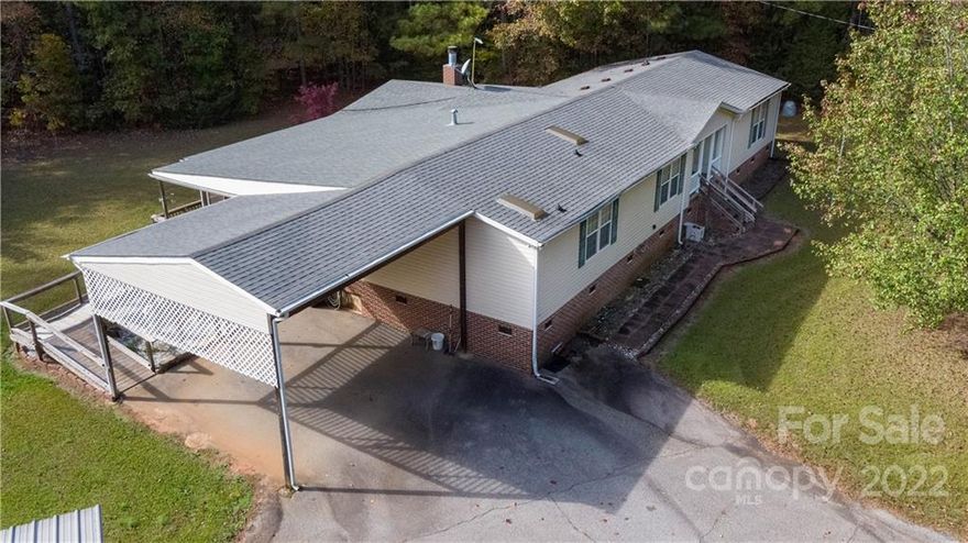 Country living with all the conveniences. Less than a mile to the Medical Health Center.  4 Minutes to the nearest grocery store/pharmacy.  30 minutes to Downtown Rock Hill.  1 hour to Columbia and 1 hour to Charlotte. This home sits several hundred feet off of the road surrounded by trees.  It features a split floor plan.  The primary includes a large walk in closet and en suite bathroom with garden tub and shower.  The other bedrooms are generous in size, one has its own full bath.  The kitchen is open and spacious with a breakfast bar.  It looks into the main living room, and also has entry into the separate dining room.  The back door enters into the mud room/laundry room.  For added convenience, there is a family room with a gas fireplace.  It has sliding glass doors that enter onto the screened porch, to spend your quiet days and evenings on this tranquil 11.4 AC.  Don't miss that wired workshop that is 27x45 - think of the projects and tinkering around you could do in there!