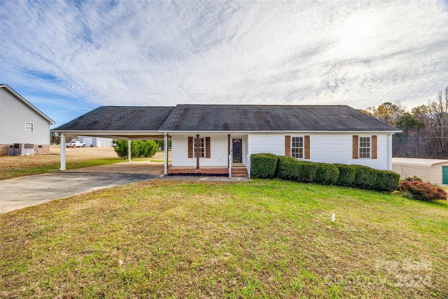 Cheerful single floor home with spacious acreage. The interior features a bright, modern kitchen with brand new stainless steel appliances and elegant white countertops; fully updated glamorous bathrooms with upgraded vanities and flattering lighting; seamless, durable luxury vinyl plank (LVP) flooring throughout; Large walk in closets in every bedroom; Ceiling fans in every room keep the house comfortable year-round. The outdoors features an expansive detached 2 story garage workshop, perfect for hobbies, projects, or extra storage. A covered carport protects your vehicles from the elements. Greet guests and sip coffee on your inviting covered front porch; entertain or relax on the sunny back deck. This charming property is situated on a peaceful, sunny setting on a generous 1 acre lot. The home offers the perfect blend of comfort, functionality and outdoor space. It is ready to impress. Schedule a showing today and make this cheerful home yours!