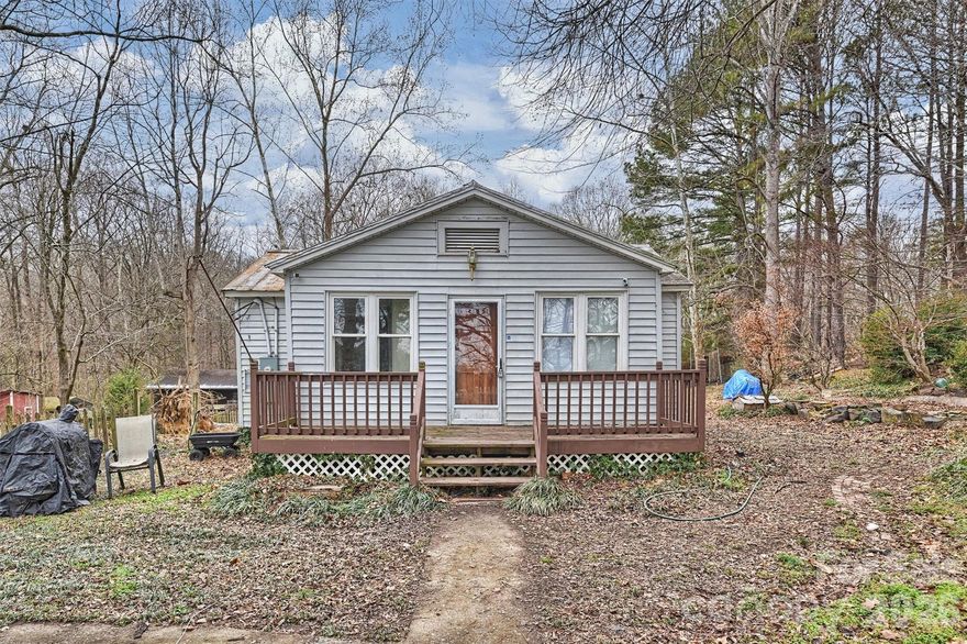 Ready to trade traffic and noise for fresh air and open skies? Your country dream starts here.

This charming 1940s home is tucked behind mature trees on nearly two acres, offering timeless character with original wood floors and a peaceful stream winding along the back of the property. The setting feels storybook — quiet, secluded, and surrounded by nature.

Start your mornings with coffee on the cozy covered porch, listening to birdsong instead of car horns. The partially wooded lot provides the perfect canvas for gardening, a hobby farm, all your animals, or simply creating your own private retreat.

Surrounded by rolling hills and picturesque horse farms, yet just minutes from quaint downtown Oakboro and Locust City Park, this property offers the rare balance of countryside serenity and small-town convenience.

Whether you envision a homestead lifestyle or a weekend escape from the city’s pace, this special property is ready for its next chapter — and yours.