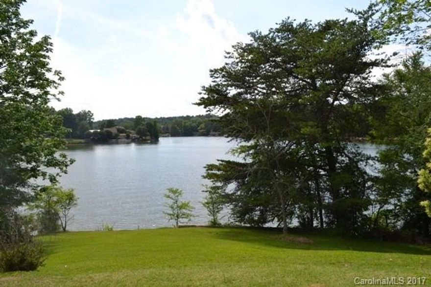 This home sits on a large and beautiful lot overlooking Lake Wylie.  400' of water frontage and is dockable.  Replacement windows throughout. Two wells on the property, newer gas furnace.  Two large bedrooms on main level with a hall bath, two additional bedrooms and two full baths on lower level.  Huge living room and dining area for those great family gatherings at the Lake. Tons of potential in this home to make it uniquely yours! Home is not a part of the HOA for River Ridge.