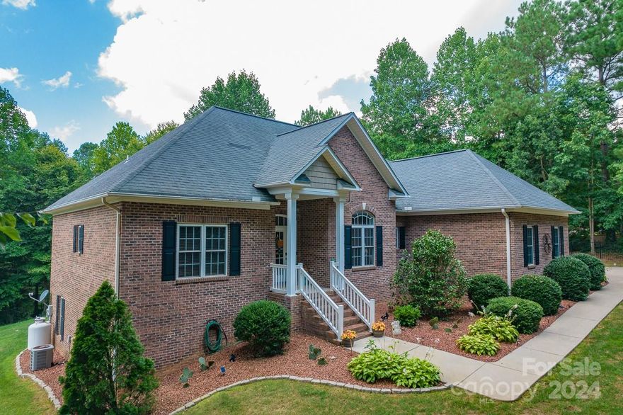 All-brick 4 BR & 3 BA's home, nestled on a wooded lot on Lake Hickory. The primary BR is on the main level, thoughtfully designed w/a split BR plan for privacy. The living area is adorned w/a cozy gas FP & tasteful built-in bookshelves. The primary BR features generous windows w/natural light, his & her closets, vaulted ceilings, & access to the inviting back deck. Basement transforms into a complete living space, equipped w/a convenient kitchenette, dining area, a comfortable living area, a BR, & a full BA. The potential for this versatile space knows no bounds. Additionally, you'll find two separate storage areas that can easily serve as a workshop, house toys, or store lawn equipment. Enhanced parking area for effortless turnarounds, a newly epoxy-coated garage, a secure metal entrance gate, & a fully fenced yard, ensuring both convenience & security. Step onto the back porch & relish in views of Lake Hickory or embark on a kayaking adventure for a day of relaxation on the water.