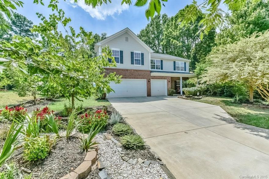 This beautiful home is move in ready with new paint and carpet. Den and full bath beyond the kitchen can be easily converted to a 5th bedroom suite. Wood flooring through out the first floor, butcher block island and stainless steel pot rack. Large private yard with shady fruit trees, extended patio, custom-built garden shed, and koi pond. 3 car garage with a workshop area. Home warranty included. Upstairs master, laundry and loft area. Gas stove, wood blinds. Great Clover schools!