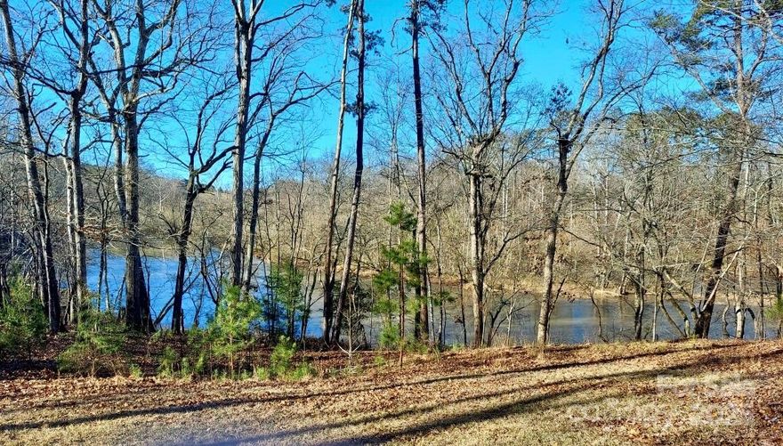 2.64 ACRES (and more land available) on Beautiful Lake Lee! Zoned R20 and dividable! If lake life is calling, look no more. Private and dreamy, and a fisherman's paradise! Directly across the street from Bridgewater and minutes to the city yet secluded and ideal for an estate life on the water. The home is situated on top of a lovely knoll for beautiful views! Three bedroom, two bath sprawling ranch with large kitchen and a 2 car garage and covered front porch. Tucked in the trees with a winding driveway that leads to the home. Please do not disturb the tenant. Lease ends in December 2025. This is such a great opportunity for private owner or developer. This property is in ETJ for Monroe. Call for a viewing today.