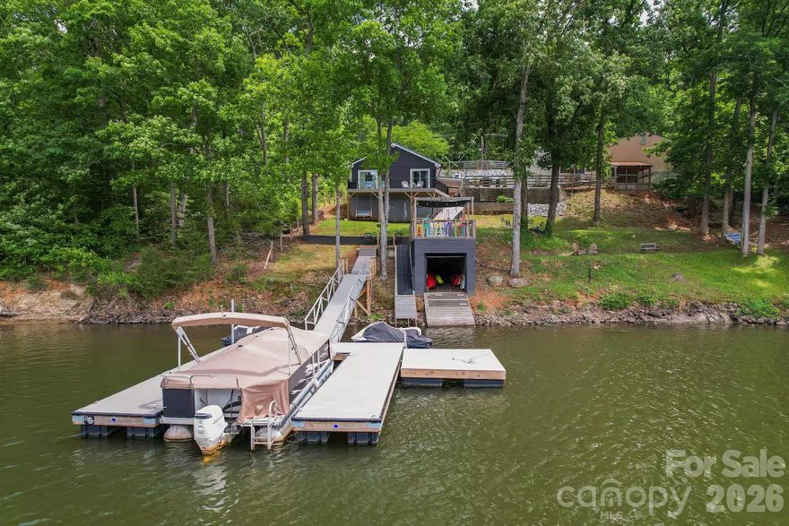 Escape to your own private lakefront retreat where relaxation and recreation come together. This beautifully remodeled home sits on High Rock Lake in the Healing Springs Estates. The property features deep water and offers the perfect setting for swimming, kayaking, fishing, and enjoying peaceful days on the lake. Whether you're looking for a weekend getaway or a full-time residence, this property delivers the ultimate lake lifestyle.

The home features a spacious primary suite on the main level, along with a secondary bedroom for convenient one-level living. Upstairs you'll find a third bedroom plus a bonus room currently being used as an additional sleeping space, ideal for hosting family and friends.

Inside the home has been tastefully updated with modern finishes and stainless steel appliances, creating a comfortable and inviting atmosphere for everyday living or entertaining.

Step outside and enjoy everything lake life has to offer. The property includes a floating dock, boathouse with roof top entertaining area, and private boat ramp, making it easy to get out on the water whenever you like. Spend your days on the water or simply relaxing while taking in the peaceful lake views. There's plenty of space to gather with loved ones and create lasting memories.

A detached garage currently used as a recreation/gameroom provides additional space for entertaining, hobbies, or game nights after a day on the lake.

Tucked away in a quiet and secluded area, this property offers the privacy and tranquility you've been looking for.

BONUS:  With an acceptable offer, the pontoon boat and home furnishings can be included, making this an increditble turn-key opportunity to start enjoying lake life immediately.