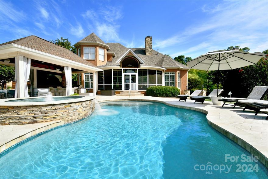 Come experience true luxury in Davidson ( Cabarrus Co side) with NO city taxes and with your own ( with private backyard basketball court and putting green) paradise in gorgeous, gated Park Creek. This custom home offers a primary bedroom down, refinished hardwoods, fabulous outdoor lighting and a true outdoor living with an outdoor kitchen plus TV, a koi pond, a saltwater pool with splash area, tanning ledge and a screened porch that expands across the whole back of the home. The first floor offers a lovely kitchen and a huge island, electric induction range, and custom trim throughout. The living area features built-ins and plenty of room to entertain. The primary suite on the main is stunning with a bay window, private entrance to the screened porch and custom closet with spa like bath w jetted tub and sep shower. Upstairs are three beds/bonus and loft and 2 additional baths. Newer carpet, walk-in storage, irrigation, water softener.. too much to mention. Must see!