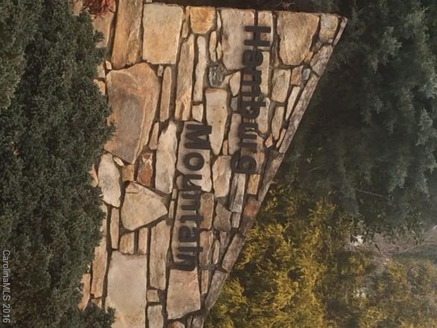 Fantastic views from this South facing mountain top lot. It's ready to build with all utilities underground including city water and sewer, and natural gas in a quiet, walkable neighborhood of upscale homes. Nice wide roads maintained by the city take you up to your new homesite. 4 minutes to Weaverville shopping and restaurants; just 16 minutes to Asheville via I-26.