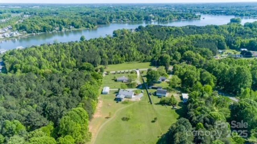 Location! Locaion! Location! Prime residential location in one of Mooresville's most desirable areas. Just a little more than a stone's throw from Lake Norman and only a 5 minute drive to Target, Groceries and Medical. 1.5 miles to Stumpy Creek boat launch.
Full brick ranch is surrounded by natural beauty, extensive landscaping, hardwood trees and lots of wildlife. 24X24  Barn Port for boat and RV storage. Newer 32X60 barn/workshop w/ finished office and 3 powered,(Hormann) overhead doors. Awesome location and setting for a Gentleman"s Farm,Wedding Venue, Family Compound, Homestead ...etc.
Home Features and Update list available in attachments.