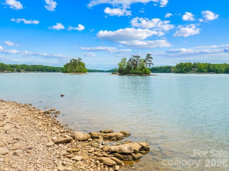 Rare opportunity to own one of Lake Norman’s most remarkable waterfront homesites. Nestled at the end of a quiet cul-de-sac within the prestigious gated community of Harbor Watch, this 1.03-acre lot offers approximately 350 feet of shoreline, an incredibly rare find that sets the stage for a truly extraordinary estate. Located on the main channel, this property captures stunning water views while maintaining a sense of privacy and tranquility. The gently sloping topography is ideal for a walk-out basement design, seamlessly blending indoor and outdoor living spaces to maximize the lakefront lifestyle. Beautifully wooded with mature hardwoods and no time limit to build, you have the flexibility to bring your own builder and design your dream home at your own pace. An off-site septic lot has already been evaluated and is suitable for a 3-bedroom home, offering added value, space and convenience as you begin planning. Whether you’re seeking a peaceful retreat or a future luxury estate, this rare lot delivers the perfect balance of seclusion, natural beauty, and premier waterfront living. Experience the best of Lake Norman right here!