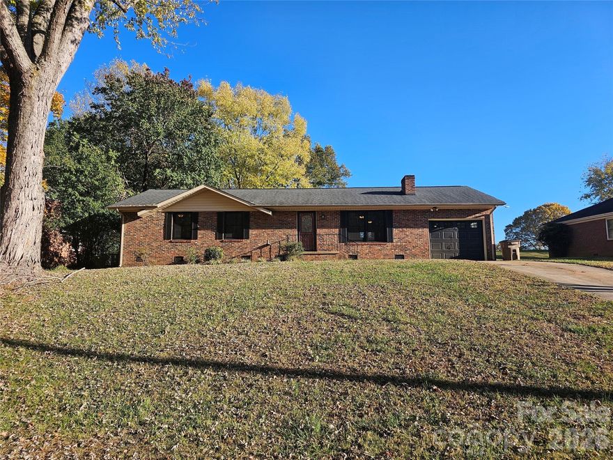 Seller is offering a $3,000 credit to buyer's at closing!  This newly renovated 3 bedroom,  2 bath home features new luxury vinyl flooring, Pella windows on the front of the home, fresh paint throughout, new lighting, and ceiling fans. Warm in front of the authentic wood burning fireplace with new screen and mantle, with an ash clean out for easy maintenance.  Cook in the kitchen with plenty of cabinetry complete with matching hardware and knobs that accent the lighting. Stainless steel appliances, gas range, and new countertops.  The primary bedroom has an ensuite bathroom for added privacy. Enjoy entertaining on the beautiful new deck.   Mature trees accent the front and rear yard while plenty of green space remains.  Garage features new garage door, garage door opener with phone app access for remote opening and closing, and show floors. Crawlspace fully encapsulated for peace of mind.  This home has been carefully updated with you in mind. Come see it today!