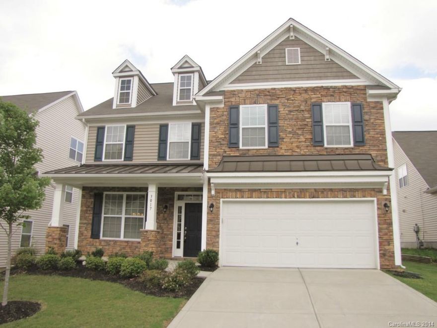 This beautiful home with stone exterior accents and a welcoming front porch has all the upgrades you're looking for, including hardwoods, 9' ceilings, crown molding and wainscoting. The floor plan includes a formal dining room, a  huge kitchen with granite counters and SS appliances, and a family room with a fireplace. The over-sized master suite features a tray ceiling, a walk-in closet, and a bath with a dual sink vanity, a garden tub and a shower. Enjoy the outdoors on the screened porch!