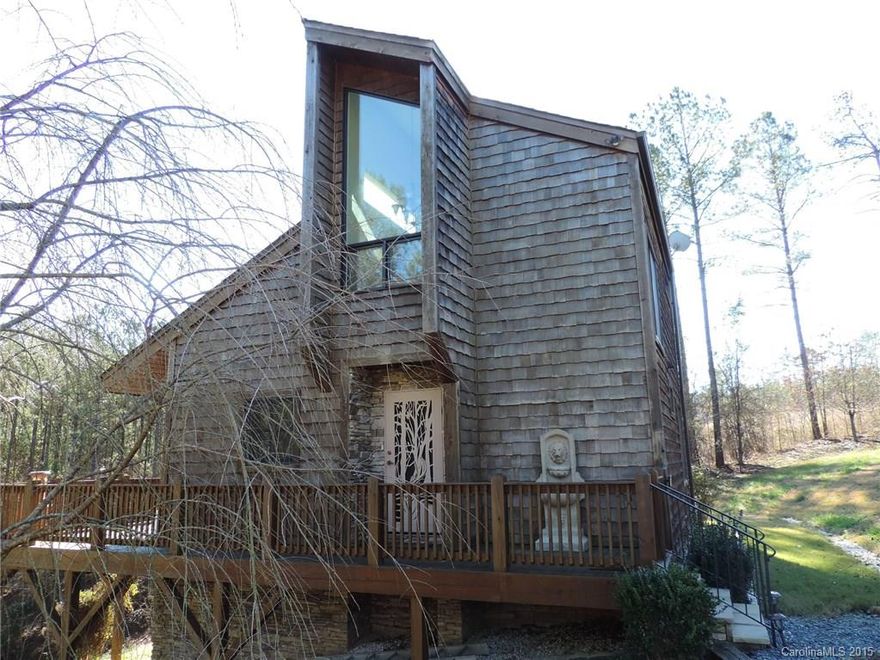 Quality Construction Custom Built home!Spectacular view off the woods on the wrap around deck.Two Driveways. Full RV Hookup available.Vaulted Great Room with recessed lighting.Kitchen has top of the line SS appliances. Corian countertop w/seamless sink, pull out drawers, lazy susan and a Trash compactor.Main Bathroom has granite countertop, tiled shower w/ glass door enclosures.Lower level has a big rec area with a walk out.Workshop area is perfect for the hobby lover.Filled with Natural light!