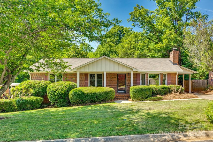 Welcome to this charming brick ranch home offers the perfect blend of comfort & convenience in established community of Harrell Estates w/ no HOA's! Covered front porch, ideal for enjoying mornings or evening relaxation. New vinyl plank flooring throughout, providing durability & modern touch. Spacious living room features a cozy gas fireplace, open kitchen w/ gas range. Home boasts 2 well-appointed beds & 2 full baths, ample space for family & guests. Primary has dual vanities & walk-in closest. Large sunroom is a highlight, filled w/ natural light & providing a versatile space for relaxation/entertaining. Outdoor living is a dream; huge covered back Trex deck, perfect for gatherings. Plus an outbuilding & gazebo, adding both functionality & charm. Attached carport w/ storage room, ensuring plenty of space for your belongings. This home is a true gem, add your updates & call it HOME! Conveniently located near Cherry Park, shopping, dining & I-77, ideal for comfort & accessibility!