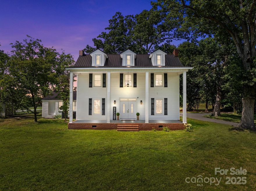 Welcome to this breathtaking 1904 colonial farm house on almost 2 acres with a circular driveway. The charm of the old comes together with the new with many rooms freshly painted, two updated bathrooms, new carpet and HVAC installed in 2024. Large Living room and Great room, both with fireplaces, high ceilings, 10” baseboards and refinished hardwood floors. Entertaining is easy with a big Kitchen and formal Dining room. Kitchen has many cabinets plus a huge walk in pantry with built-in cupboards. This home includes an Office with built-in bookcases and bright and open sunroom. Bedrooms on upper level with 2 full bathrooms and a small loft can host a desk or cozy reading space. Enjoy our southern weather on the huge covered front porch or the spacious back porch. This home is surrounded by farmlands to truly enjoy the peace and quiet. Great property to create your perfect homestead. Conveniently situated between Salisbury & Statesville and minutes from downtown Cleveland.