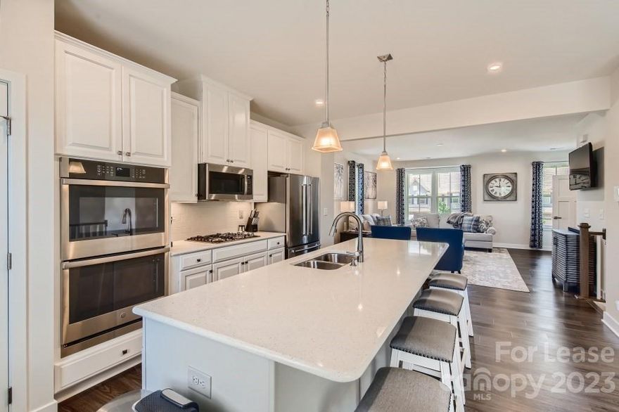 Gorgeous End Unit townhome in a great Lake Front community! Available March 15! Quartz counters, elegant tile backsplash, pantry, island, and Stainless Steel appliances including a Gas Stove. Main level is spacious and open. Sunny dining space in the kitchen with sliding doors to deck. The Primary Bedroom is spacious and has a tray ceiling and large walk-in closet. The attached primary bathroom has a dual vanity and a gorgeous tile shower. Large rec room and huge storage room are just off the two car garage. Lawn care included! Fenced backyard. Waterfront at Langtree is all about Lake Norman Luxury Lifestyle and convenience! This lakefront neighborhood sits on Lake Norman. Enjoy walking to the covered picnic and recreation area with lakefront views. Conveniently located in Mooresville, off I-77, exit 31. The Langtree Lake Norman area is between downtown Davidson and Mooresville. This community is walkable to shopping, dining, and special events and is very close to highway I-77.