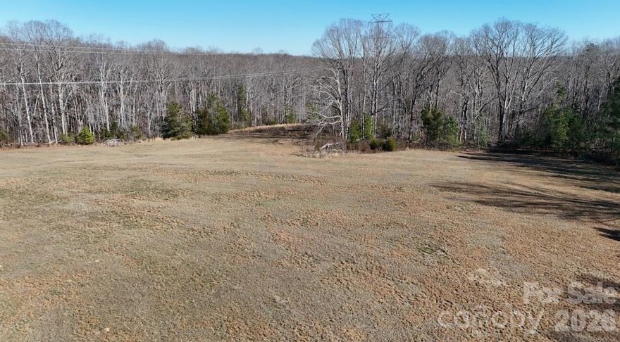 This versatile 89 acre (+/-) tract presents an outstanding opportunity for investors, developers, and land buyers seeking long term value in a growing Carolina market. The property offers a balanced mix of open, tillable ground and mature timber, making it suitable for agricultural use, recreation, timber management, or future development. With productive fields and attractive wooded acreage, the land provides both immediate utility and long range upside.
Access is a major strength of this parcel, with frontage along Highway 55 West and C.E. Stewart Road, giving the property excellent visibility and multiple entry points. This level of paved road access adds flexibility for subdivision, estate development, or continued agricultural operations. Partial fencing is already in place, and the tract includes two storage barns in good, usable condition for equipment, hay, or operational needs.
An older homesite exists on the property and, while the structure itself holds no monetary value, it has already established key infrastructure. A well and electrical service are in place and previously served the homesite, offering a valuable head start for future construction or improvements. Rocky Branch Creek originates on the property and flows year round, adding character and natural appeal without major floodplain constraints that would limit development.
Located just 10 miles from Two Kings Casino, this tract benefits from proximity to one of the strongest economic drivers the region has ever seen. As growth continues to push outward from this corridor, properties with size, utilities, access, and mixed land use like this become increasingly valuable. Whether your plan is investment, residential development, farming, recreation, or a long term land hold, this 89 acre tract offers location, infrastructure, and potential in one compelling package.