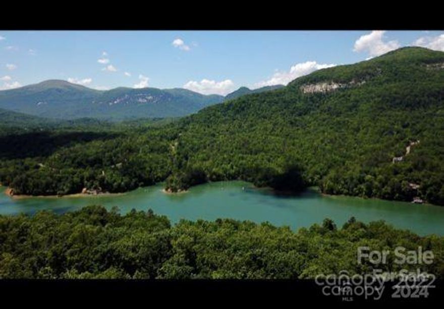 VIEWS VIEWS VIEWS.    Stunning lot with potential magnificent views of Lake Lure, Rumbling Bald and Chimney Rock once some trees have been removed.  Build your dream home on Millionaires Row!  A topographical survey has already been done on this lot with all markers still in place.  Short term rentals are allowed in this subdivision.  Rumbling Bald boasts two world class golf courses, indoor and outdoor swimming pools, a lazy river, mini golf, tennis courts, fitness center, restaurant and its own private beach.  This lot is one of the few that  are readily buildable with a gentle slope closer to the road.