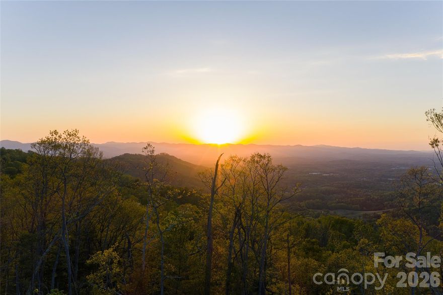 A rare opportunity to acquire one of Western North Carolina’s most compelling legacy holdings, offering approximately 36 acres of expansive land along the iconic Elk Mountain Scenic Highway. Positioned at elevations exceeding 3,000 feet, this offering captures the essence of privacy, scale, and sweeping, year-round views of the Blue Ridge Mountains. The landscape is defined by rolling ridge-lines, natural knolls, mature hardwood forests, and tranquil streams creating an immersive and secluded setting. The terrain is well-suited for architecturally significant residences designed to maximize long-range mountain vistas and privacy, while accommodating private trail systems, outdoor living spaces, and thoughtful land stewardship. The property remains conveniently close to Asheville’s celebrated dining, cultural amenities, healthcare, and everyday conveniences which include the Country Club of Asheville and Blue Ridge Parkway both of which are mere minutes away.  Final acreage to be determined. Whether envisioned as a private estate, generational compound, future development opportunity, or long-term investment, this offering represents a rare chance to secure meaningful acreage with views, elevation, and flexibility in one of Western North Carolina’s most enduring and desirable mountain corridors. A separate MLS listing is available offering additional contiguous acreage for those seeking to expand the scope of their vision.