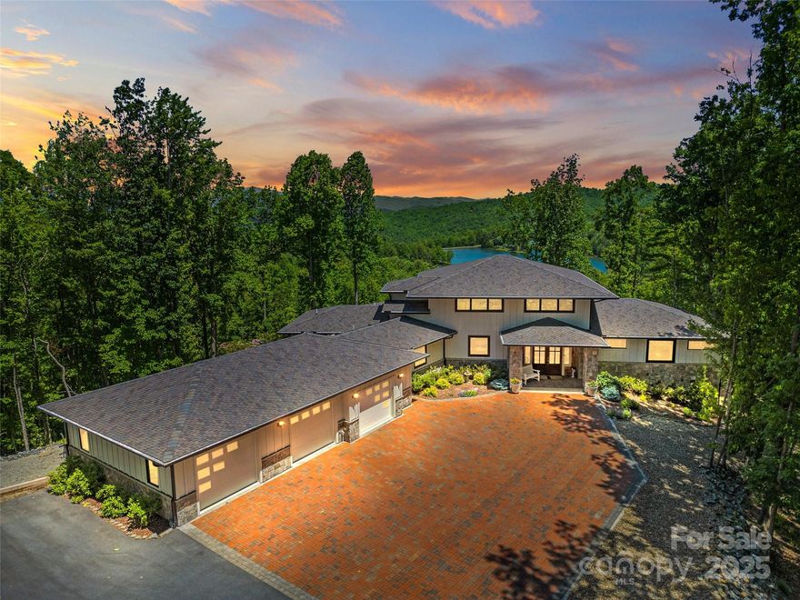 One of the most stunning views in WNC. This is a home and property that delivers an experience and wow factor that defines extraordinary! The large 6-acre property has very mild deed restrictions with room for additional houses or hobby huts. Natural granite boulders mark the entryway to the property as the house and sweeping views come into focus. Inside the practically new home, you are greeted by soaring ceilings and a wall of windows framing the spectacular view of Blue Ridge Parkway and Eagle Lake in the foreground. Obviously, a home of this caliber offers one-level living under meticulous care. The lower level offers all the overflow guests and entertaining space, both indoors and out, with extras including a gym, steam room, hot tub, and masterfully hardscaped patio. Located just minutes from historic downtown Brevard, Dupont State Forest, Cedar Mountain, and Asheville Regional Airport. Nassua Ridge offers the pinnacle of living in WNC. See Virtual Tour Video