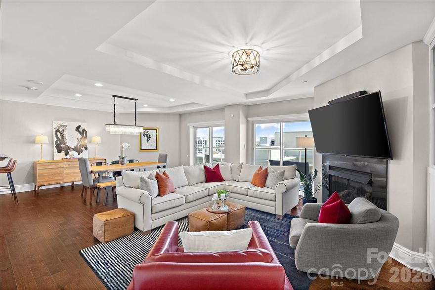 Experience elevated city living in this stunning 2-bedroom, 2.5-bath condo at The Madison, an exclusive boutique building with just 26 residences. Perched on the 11th floor, this home offers sweeping views of Uptown Charlotte from a private covered terrace—perfect for morning coffee or evening unwinding. The main level features an open-concept layout seamlessly connecting the kitchen, dining, and living areas—ideal for both everyday living and entertaining. The kitchen is beautifully appointed with granite countertops, a breakfast bar, wine cooler, and new appliances. Upstairs, retreat to a spacious primary suite complete with a sitting area, an oversized walk-in closet, and a luxurious ensuite bath featuring a soaking tub and glass-enclosed shower. A second bedroom with built in desk and bookcases does double duty as guest suite and office.  Convenience of in-unit laundry room on the same level complete the upper floor. Located just minutes from Charlotte’s best restaurants, nightlife, and entertainment, this condo offers the perfect blend of comfort, style, and city convenience.