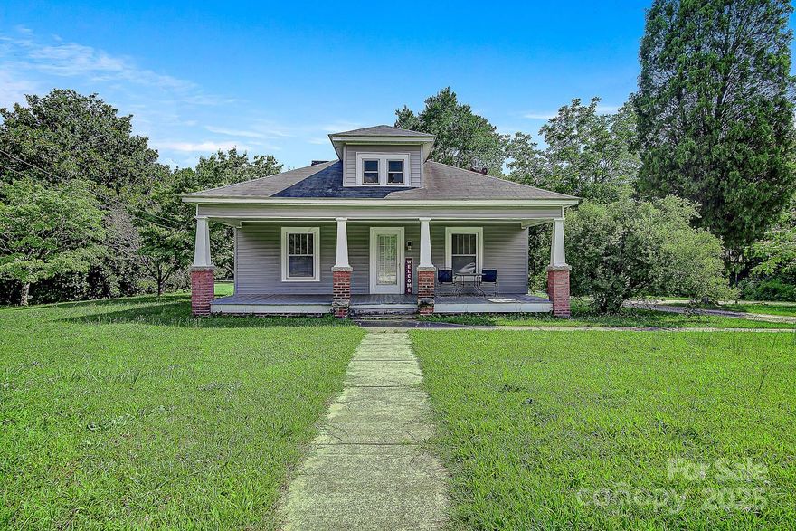 Discover an incredible investment opportunity with this charming 3-bedroom, 1-bath home set on 1.85 acres of prime land, offering versatile RMX zoning options. Boasting over 1,500 square feet of living space, this property features generously sized rooms, including a cozy living room with a fireplace, a large dining area, and a spacious kitchen. Relax on the covered front porch, perfect for rocking chairs, or enjoy views of the serene "field of dreams" back yard. With endless possibilities for growth and development, this property is your chance to bring your vision to life. Don’t miss out on this unique opportunity!