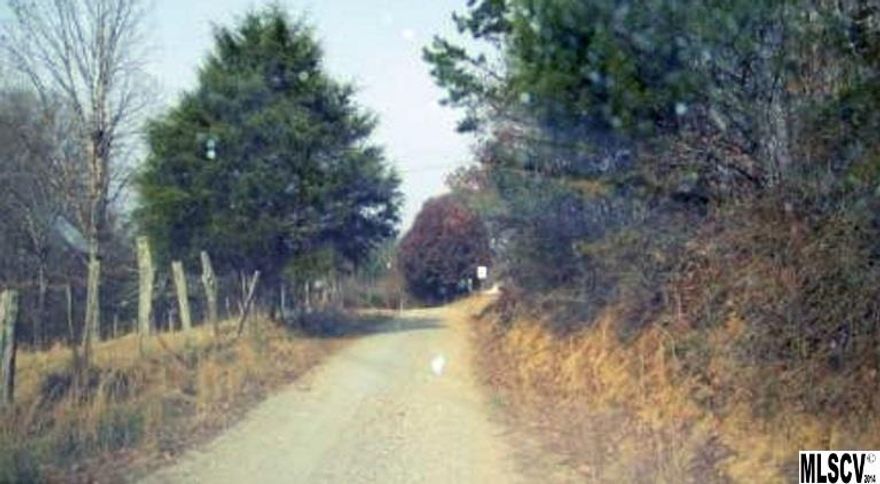 Almost 13 Acres mostly wooded with small one bedroom house that has low ceilings & no heat. Being sold "as land" only.