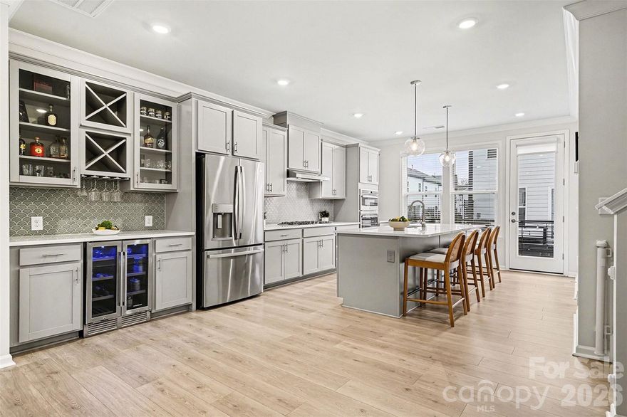 Buyers, you can receive up to 1% lender credit if you work with preferred lender. Built in 2024, this like-new 3-bedroom, 3.5-bath end-unit townhome offers abundant natural light with oversized windows and tall ceilings throughout.

The entry level includes a two-car garage and flexible space with a full bath, ideal for a guest suite, office, or additional living area; plus a charming front patio that faces natural area to provide privacy.

The main level features an open-concept design with a gourmet kitchen, oversized island, rare walk-in pantry, gas fireplace, half bath, and a private balcony for easy indoor-outdoor living.

Upstairs, the spacious owner’s suite includes a large walk-in closet, along with two additional bedrooms and a convenient laundry room.

Community amenities include a dog park and dog stations—making this bright, thoughtfully designed home truly move-in ready.