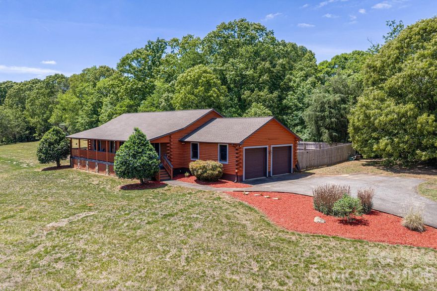 Attention Investors! Rare opportunity to own a rustic log home on 2 acres in a peaceful Eastern Lincoln County setting! This 3-bedroom log home features a desirable split-bedroom floor plan, offering added privacy with a spacious primary suite complete with a walk-in closet. Inside, you’ll find vaulted ceilings with exposed beams that enhance the home’s warm, cabin-style character, wide plank Tennessee southern pine wood flooring, along with a granite kitchen and inviting living spaces filled with natural light. Step outside to the expansive front porch the length of the home—perfect for relaxing and taking in the serene surroundings. Major updates include a newer HVAC (approx. 3 years), appliances (approx. 5 years), and new water heater, providing a solid foundation for future improvements. With no HOA and 2 acres to enjoy, you’ll have some freedom to create your ideal retreat, primary residence, or investment property. While the home does need some TLC, it presents a fantastic opportunity to add value and make it your own!  Conveniently located with quick access to Hwy 16, making for an easy commute to Charlotte, Denver, Lake Norman and surrounding areas while still enjoying the quiet of country living. Don’t miss your chance to own a unique log home with instant equity!