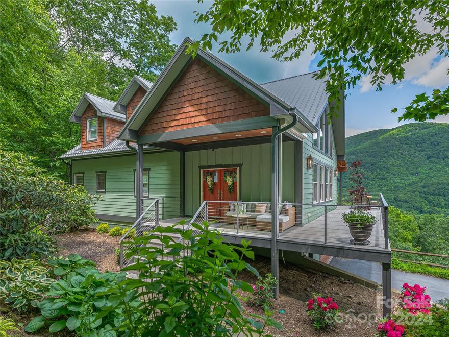 Nestled in the tranquil gated community of Laurel Ridge, this home boasts awe inspiring long range views of the Black mountains and Blue Ridge Parkway. The luxurious and spacious floor plan is perfect for entertaining, with ample space and privacy for guests. The updated gourmet kitchen features top-of-the-line appliances, sleek new cabinets and craftsmanship from local artisans. Spread across 3 lots, this 4.3 acre estate provides a sense of exclusivity and serenity. Recent upgrades include a new metal roof and a fresh coat of exterior paint ensuring durability and peace of mind for the new owners. Both the upper and lower decks offer idyllic spaces to soak in the natural scenery. For added comfort and convenience, the property is equipped with a whole house generator, misting system for bug control, electric sunscreens, and manicured native landscape. The lower deck features a large hot tub, perfect for unwinding amidst nature's beauty.