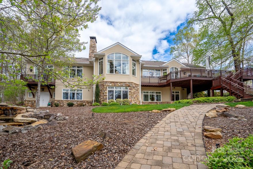 This well-maintained lakefront home has it all! Impressive stone front entry leads inside to Great Room w/vaulted wooden ceiling, white oak floors & custom stone fireplace. Spacious chef's kitchen w/oversized natural stone island/wine fridge. Separate den w/fireplace. Luxurious owner's suite w/private balcony. 2 full bedroom suites downstairs, den w/fireplace, plus a workout room. Flex space w/full bath over attached 2-car garage. Spectacular space to entertain guests on the back deck & sunroom overlooking Badin Lake & Old North State Club’s 14th hole. Gentle walk down a paver path to your private pier! Attractive custom stone water feature adds to the tranquil ambience. Spacious storage downstairs. A large wine cellar, plus a golf cart/boat storage bay on lower level. This immaculate home is only an hour's drive from Charlotte, the Triad & just a bit further from Raleigh! Join the Old North State Club to enjoy the recently renovated Tom Fazio golf course, courts, pools, dining & more.