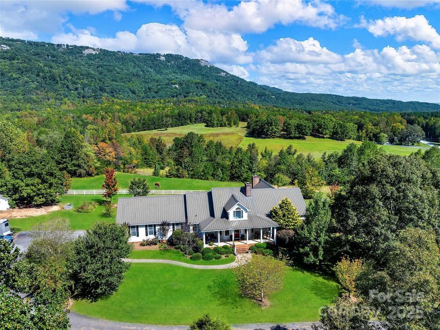 Surrounded by expansive mountain views, this 15.5-acre property offers an easy, functional layout, private setting, and well-planned space for horses—all in one of Landrum’s most convenient locations.

The 2,400-sq-ft home includes three bedrooms and two baths, designed for main-level living with a great flow throughout. The living room is anchored by a full stone fireplace and picture windows that frame the mountain view. The kitchen opens naturally to the dining and living areas, keeping everything connected. The primary suite adds another fireplace, dual vanities, and an adjoining office or sitting room—ideal for anyone who works from home or wants a quiet retreat.

Outside, the setting is as usable as it is scenic. The three-stall barn offers walk-out stalls and a spacious tack and feed room. White three-board PVC fencing lines the property and large pastures, one equipped with a run-in shed. The riding arena—now naturally grass-covered—is well sited and could easily be brought back into use. A gated entry and paved drive greet you upon arrival, while the Middle Tyger River creates a natural border along the edge of the property.

Gated, private, and perfectly sited, 2134 Highway 11 captures the best of Landrum living—minutes from Greenville, Spartanburg, Travelers Rest, and Hendersonville—for the buyer who values a great floor plan, room for horses, and mountain views that never get old.