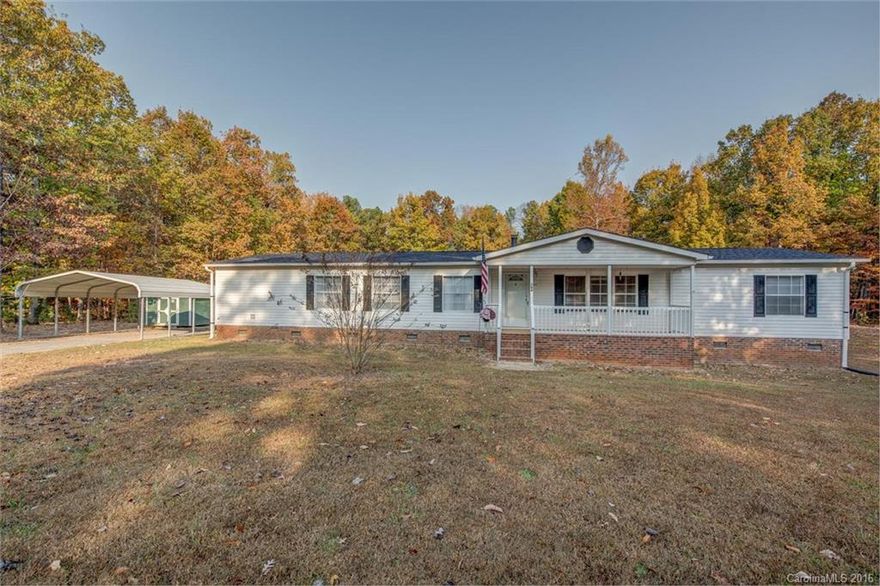 4 bedroom home on cul-de-sac with woods behind. You will love the privacy this home has to offer with a rocking chair front porch and large rear deck. Great floor plan with both formal and informal living rooms, gorgeous stone fireplace, master suite with attached flex-room for many uses, corner jet tub, dual vanity, and separate shower. Large storage building and carport enhance the property!