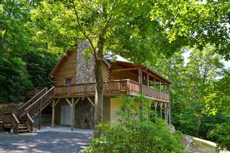 SPECTACULAR VIEWS...Own your own slice of Blue Ridge Mountain Heaven!  This Southland Log Home built in 2002 is your perfect dream getaway...very quiet, peaceful and private, located within minutes of Linville Falls Golf and Country Club, Linville Falls, Grandfather Mountain, The Blue Ridge Parkway, Boone, various ski slopes and other Blue Ridge Mountain attractions.  Enjoy views of the Blue Ridge Parkway from the large front porch and almost any room in the cabin.  Three bedrooms (loft area being used as a bedroom), two baths, large open great room with stone fireplace (currently with gas logs, but can burn wood), laundry room, workshop area in basement...nothing left undone! A must see!