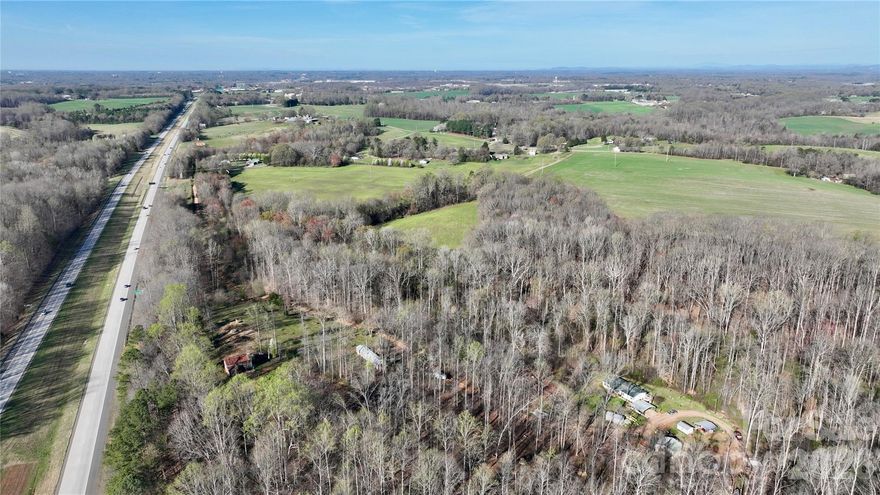 This 39.8 +- acre prime Iredell County tract offers a rare combination of agricultural productivity and strategic logistical placement. Currently maintained as active farmland, the property features expansive, mostly cleared acreage, to expand an agricultural operation, build a private homestead, or invest in land with future development potential. Its proximity to major interstate corridors (I-77 and I-40) ensures effortless connectivity to Statesville, Mooresville, and the greater Charlotte area, while maintaining the quiet, rural character the region is known for. With significant road frontage and well-managed soil, this versatile parcel is perfectly positioned for those seeking a "turn-key" land opportunity in one of North Carolina’s fastest-growing counties. The property features open fields with productive soil, gentle topography, and ample space for crops, livestock, or equestrian use. New survey on file.