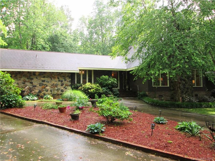 Secluded among hardwoods, this 4024 +/- sq ft 5BR/4BA eclectic home on 4+/-Ac, overlooks a beautiful stocked neighborhood lake. MST on main, fireplace, handicapped Ste. Newly updated upstairs includes new flooring, new paint, plus new fixtures & mirrors in baths, new stairs, new railings. 506+/- sq ft walk-out basement, in ground pool, pool house w/shower, new paint & ceiling fans. New landscaping & fencing, lighted tennis/basketball court. Seller offering $10,000 decorating allowance, or...