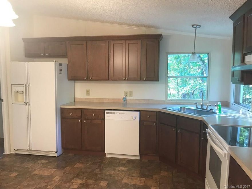 Updated and Move-In-Ready! This one won't last long! New kitchen cabinets, flooring, light fixtures, appliances and paint.  New roof 2016. New decks on the side and back of home. This is a gem with a large level lot with plenty of outdoor storage and work space. Clean and well maintained home! Mature trees and lots of privacy! Interior photos coming.