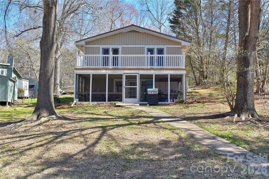 This waterfront home is located off Badin Lake's main channel in the cove between Pinehaven and Lake Forest. All-stationary pier in excellent condition, with boat slip. Cube/Yadkin pier #802. Great swimming and fishing areas. Easy walk to the water and the pier along the concrete walkway. The lower level features an open kitchen and living area along with the 11x24 lakeside screened porch. Lakefront grilling area. The upper level includes 3 bedrooms, all of which have ceiling fans, windows, and closets. 2 of the bedrooms have water views and include doors with direct access to the upper lakeside deck. Some furniture negotiable. County water & sewer. Gravel driveway; ample parking. Private Pinehaven boat landing within the neighborhood. Convenient to the lake’s marinas that provide dining, gas, and watercraft rentals. The Uwharrie National Forest nearby is a great destination for camping, hiking, horseback riding, and ATV/OHV trails. Within 1 hour from Charlotte, Greensboro, Winston-Salem, and Pinehurst.