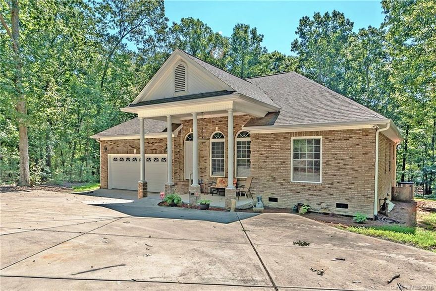 All brick home - 9.34 AC/2 car attached garage, front porch, large screened porch across back of home w/lots of privacy. 10' ceiling in Great RM, Foyer, Master. Hardwood floors/Great RM fireplace/bookcases. Master BR walk-in closet, heavy molding, hardwood floors. Master BA - separate shower/Jacuzzi tub. Open Kitchen w/ bay window, hardwood floors - 3BR/2 full BA w/ office, playroom, & 770 sqft workshop heated/cooled. New Security System. All appliances remain. Lake view. Lake does not convey.